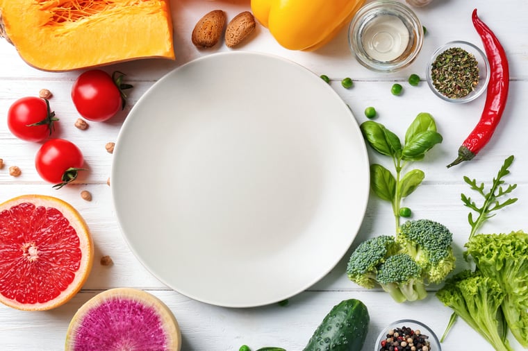 AdobeStock_247758043_plate surrounded with healthy food